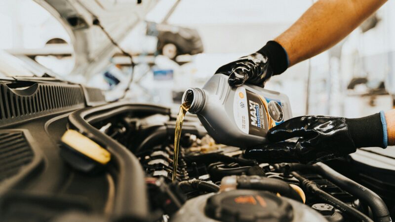 mechanic changing oil in vehicle